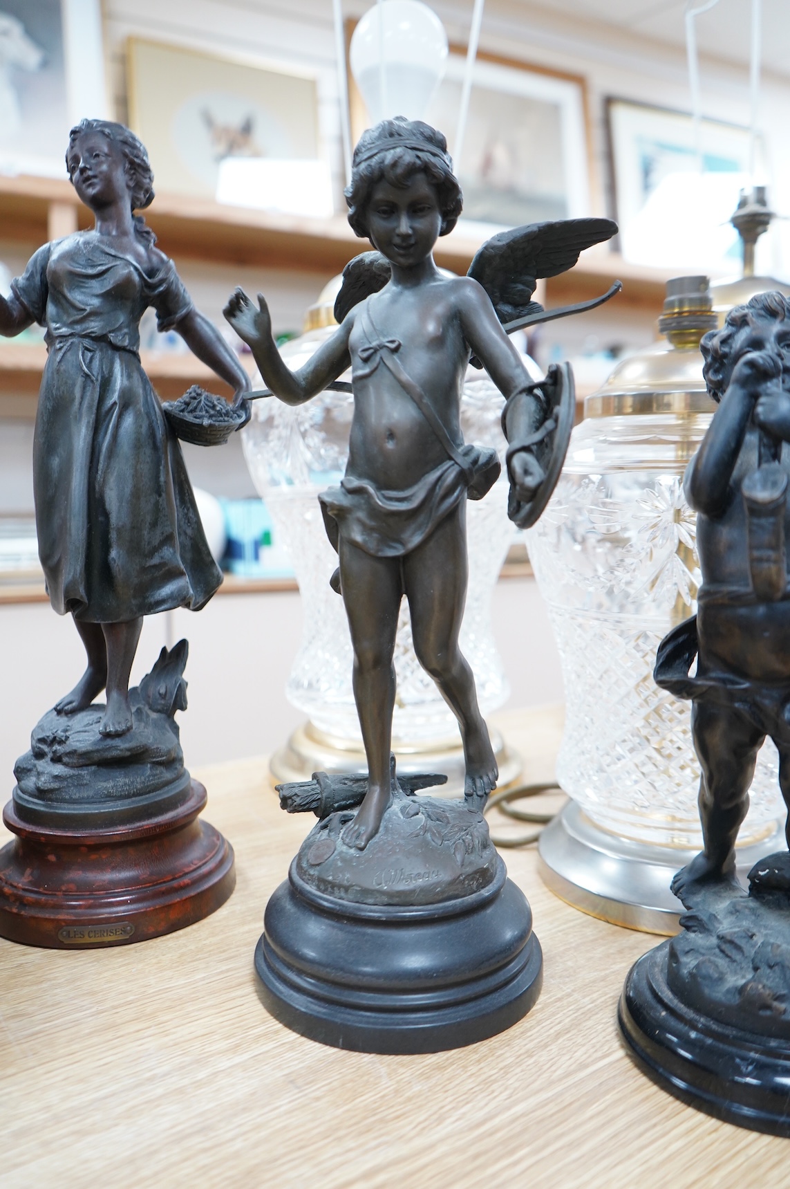 After Moreau - three statuettes, two bronze cherubs and a patinated spelter maiden, ‘Les Cerises’